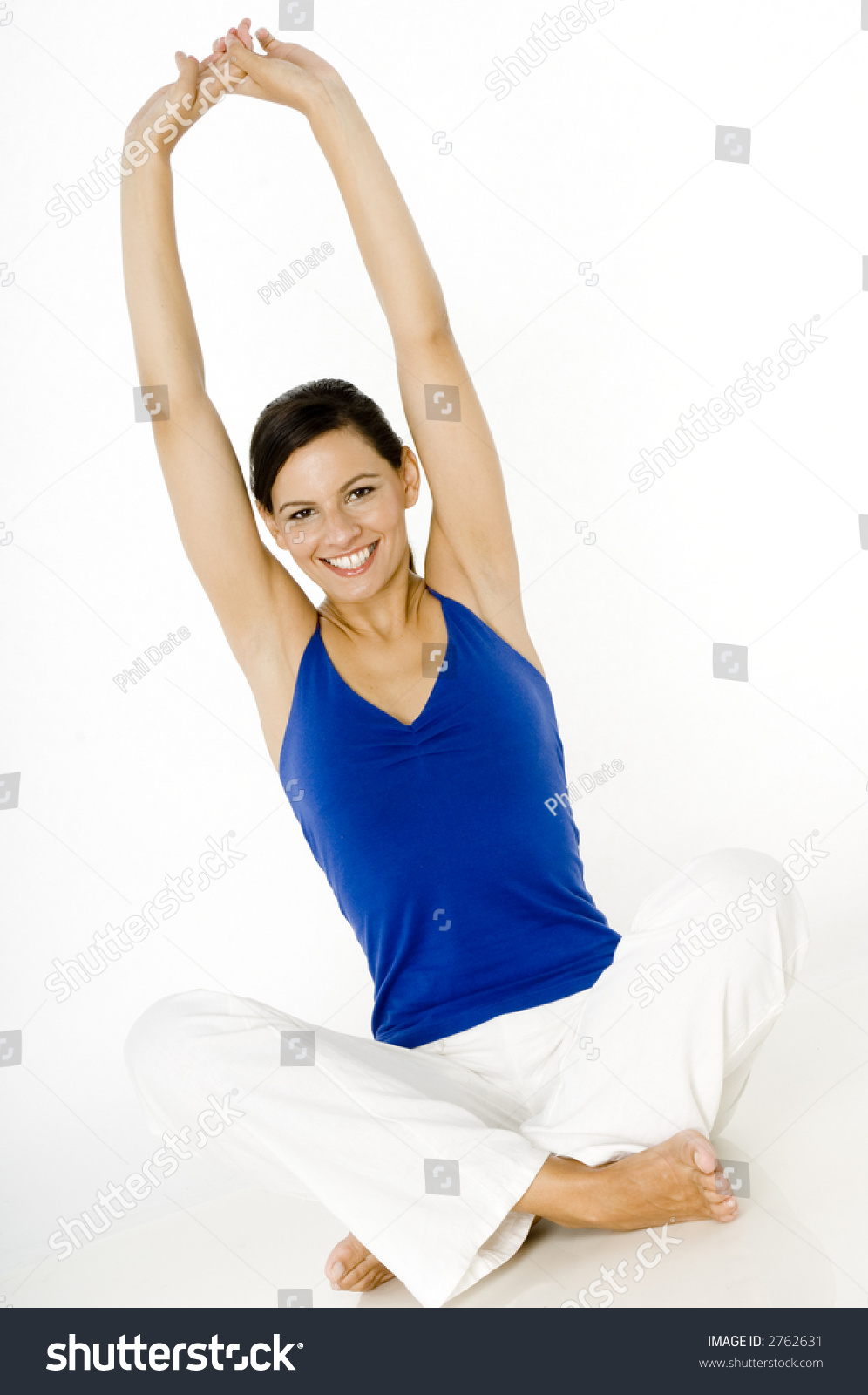 A Young Woman Sitting On The Floor Stretching Her Arms Upwards Stock ...
