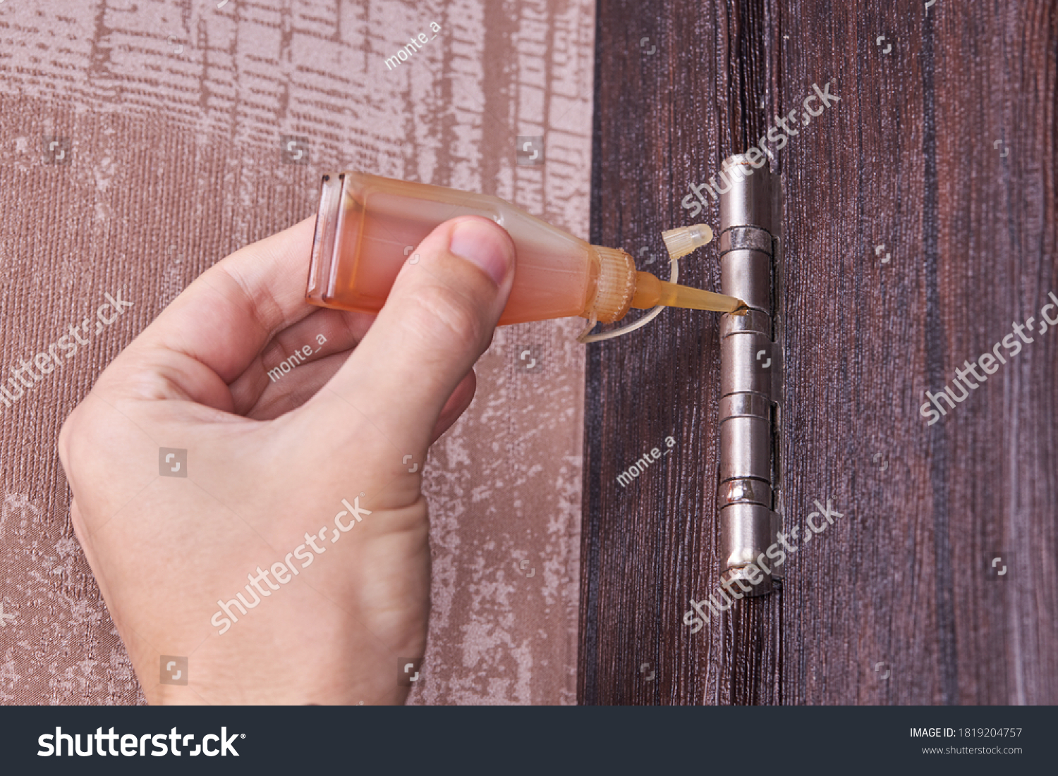 Adjusting Door Hinge Using Lubricating Oil Stock Photo (Edit Now