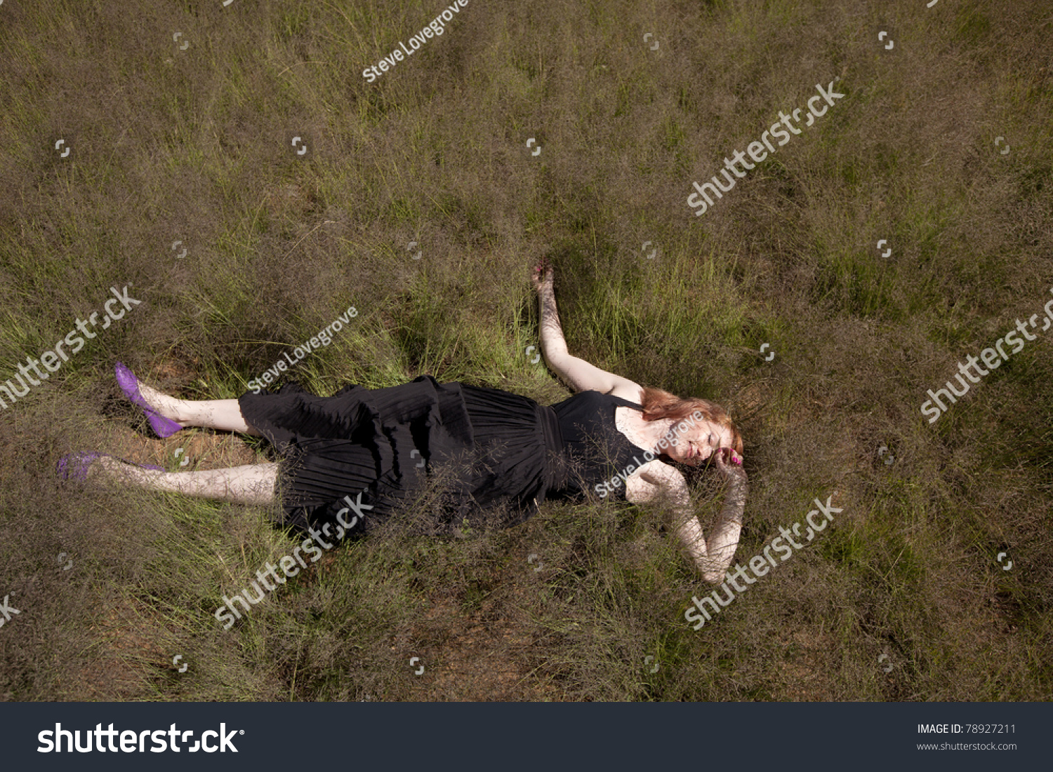 Aerial View Of Girl In Long Dress Lying On Her Back In Field Of Long ...