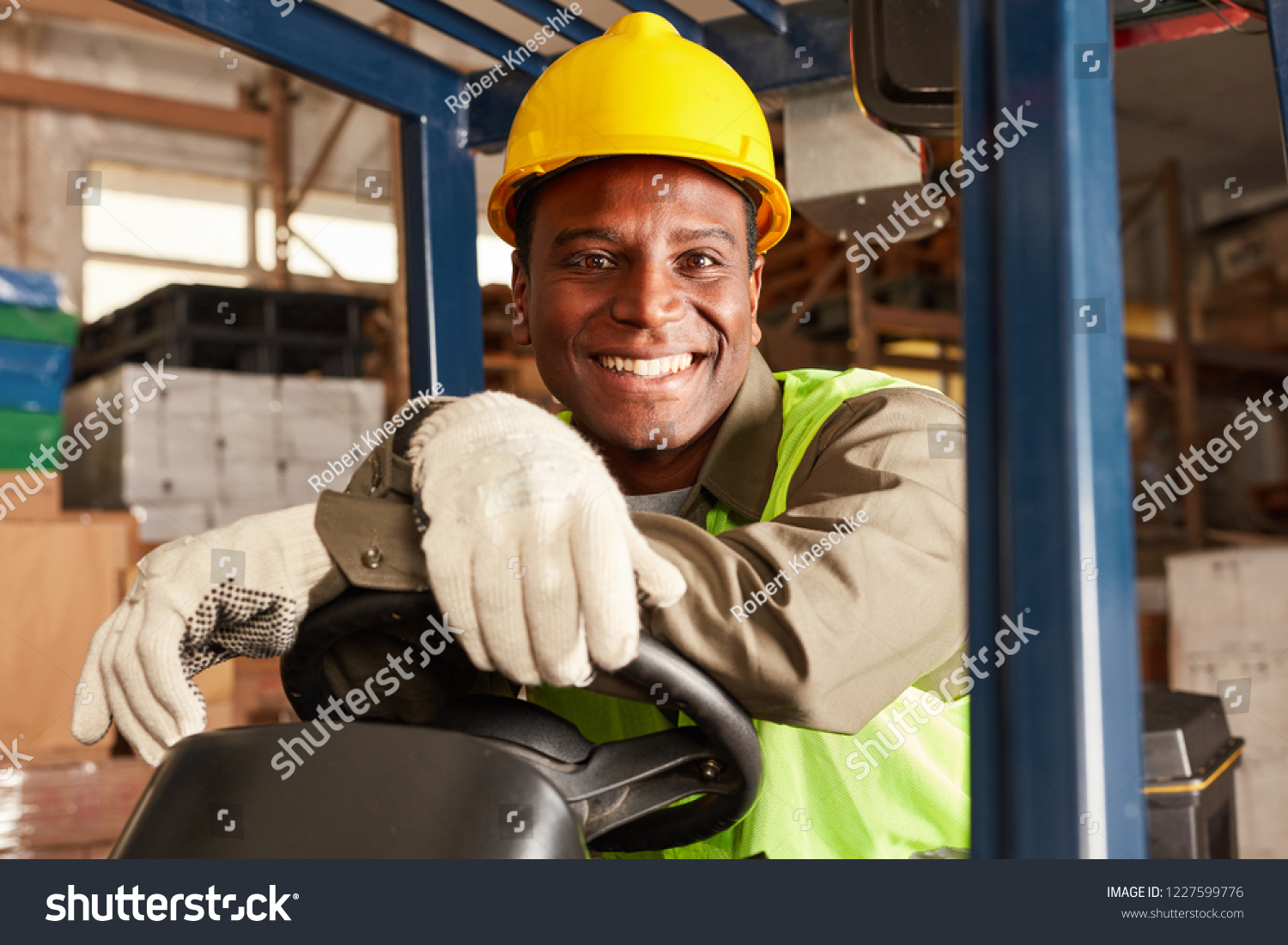 African Logistics Man As A Forklift Driver In The Warehouse Of A