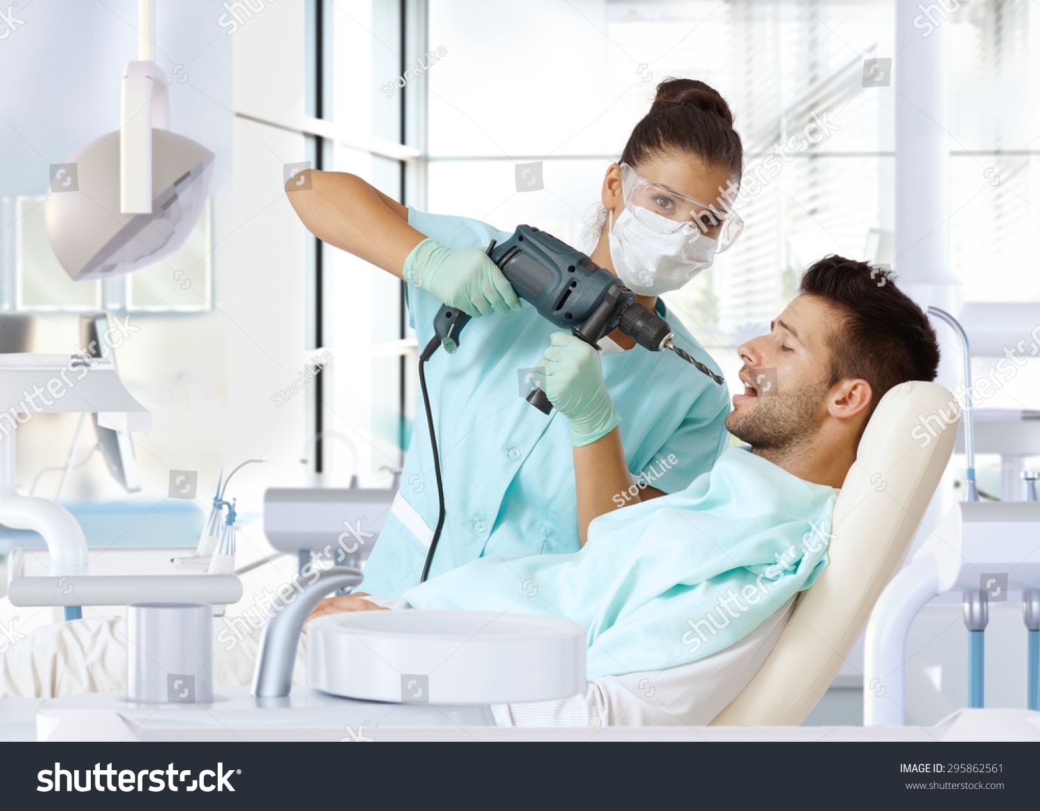 Aggressive Female Dentist Using Power Drill For Drilling Patient'S ...