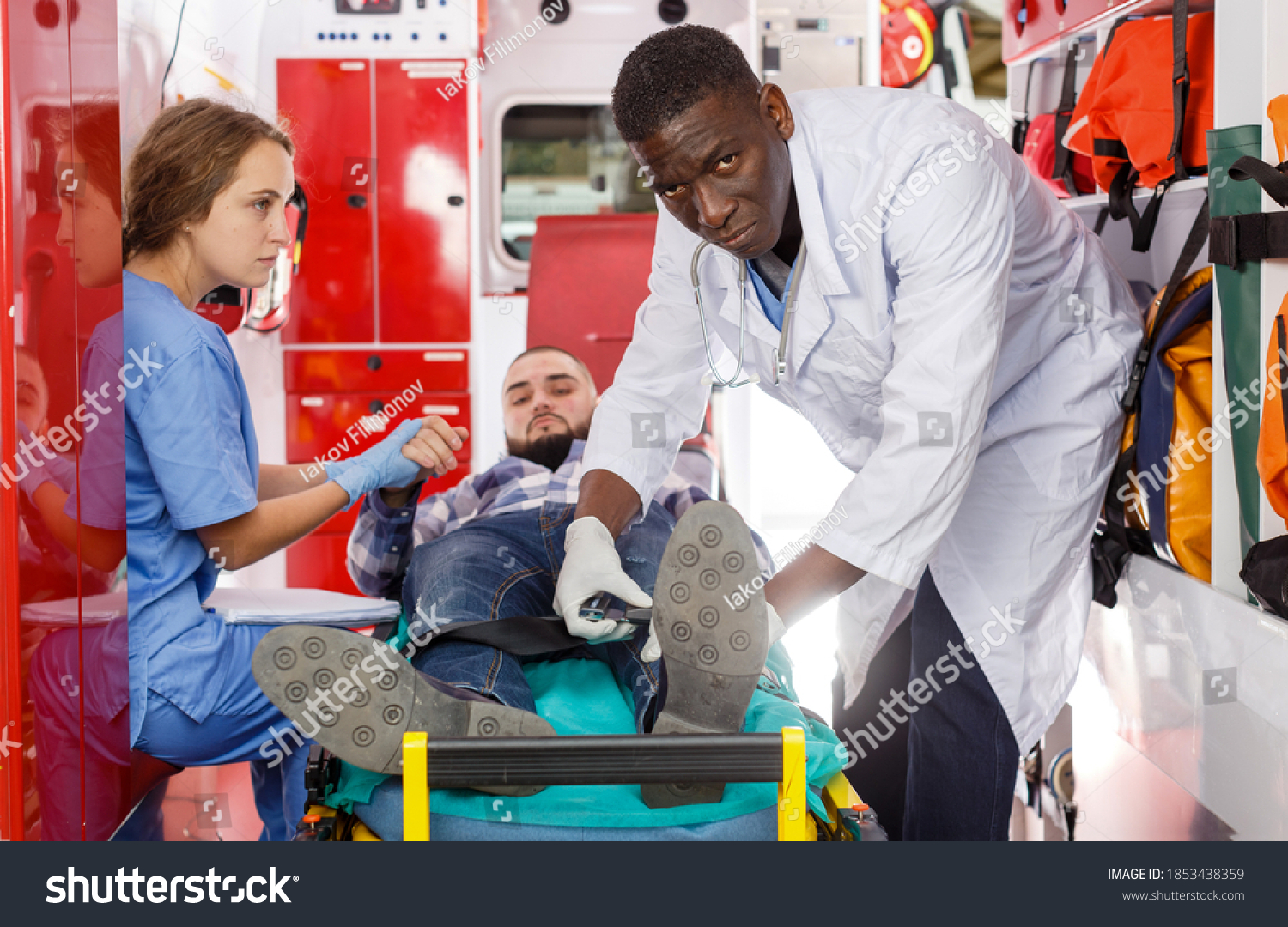 Ambulance Team Laying Patient On Stretcher Stock Photo 1853438359 ...