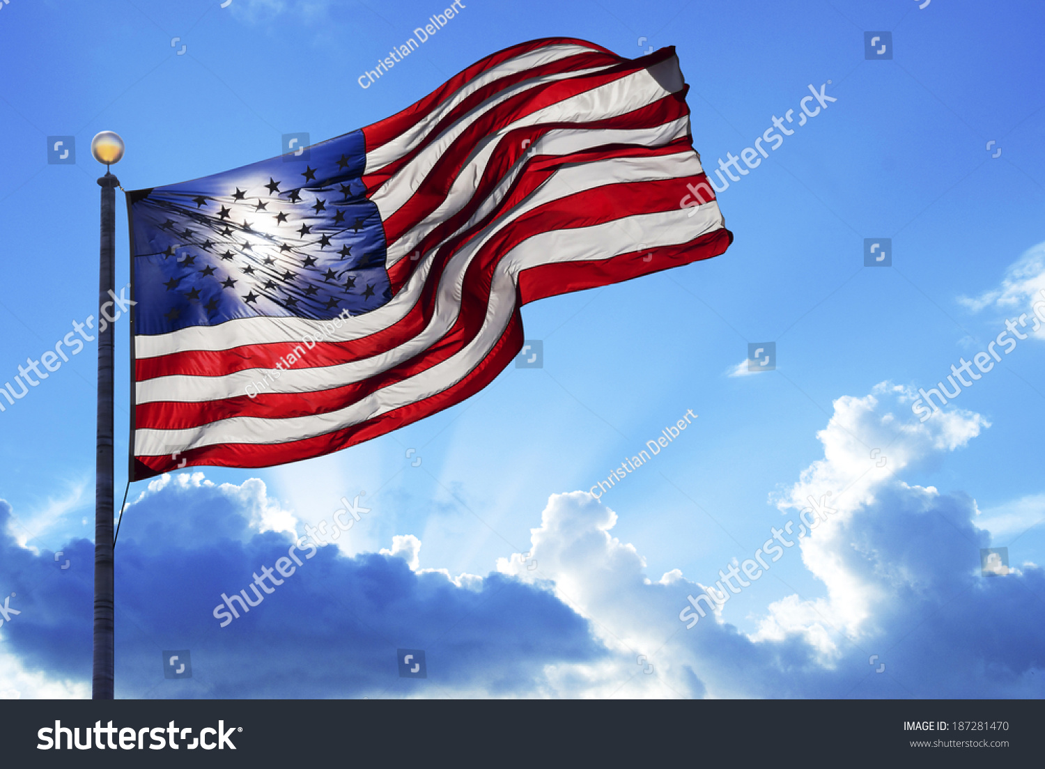 American Flag Fluttering In The Wind Under A Cloudy Sky Stock Photo ...