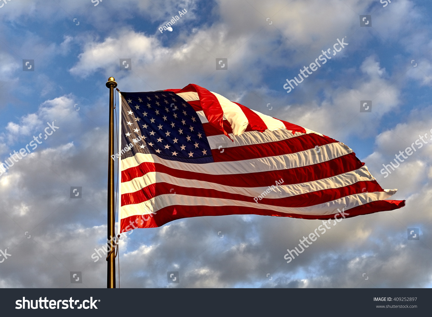 American Flag On Flagpole Waving In The Wind Against Clouds, Blue Sky ...