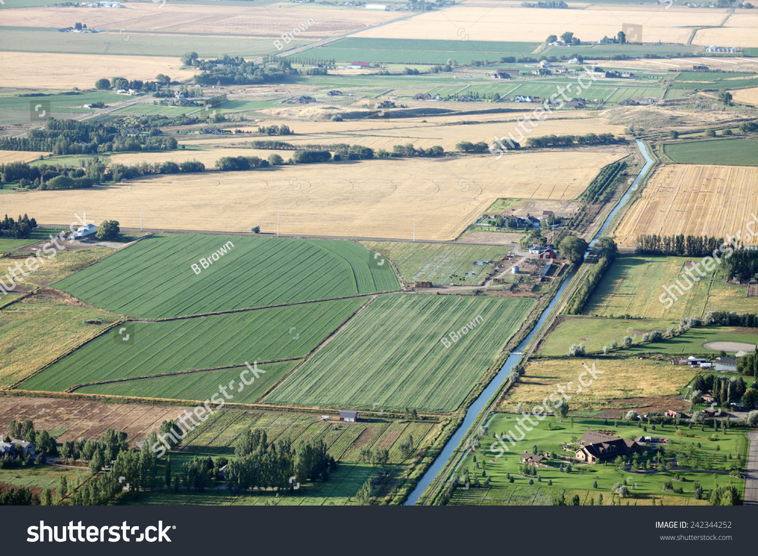 An Aerial View Of Farmland With Canals, Flood Irrigation, And Pivot ...