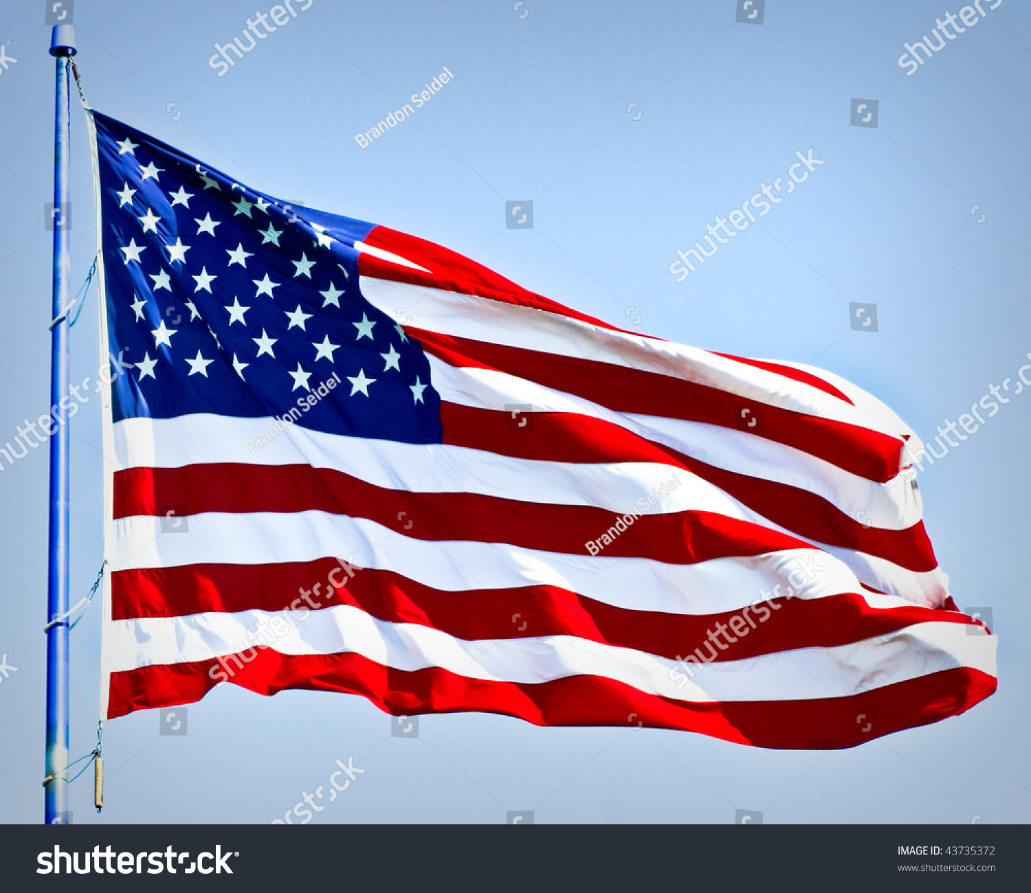 An American Flag Boldly Flying In The Wind Stock Photo 43735372 ...