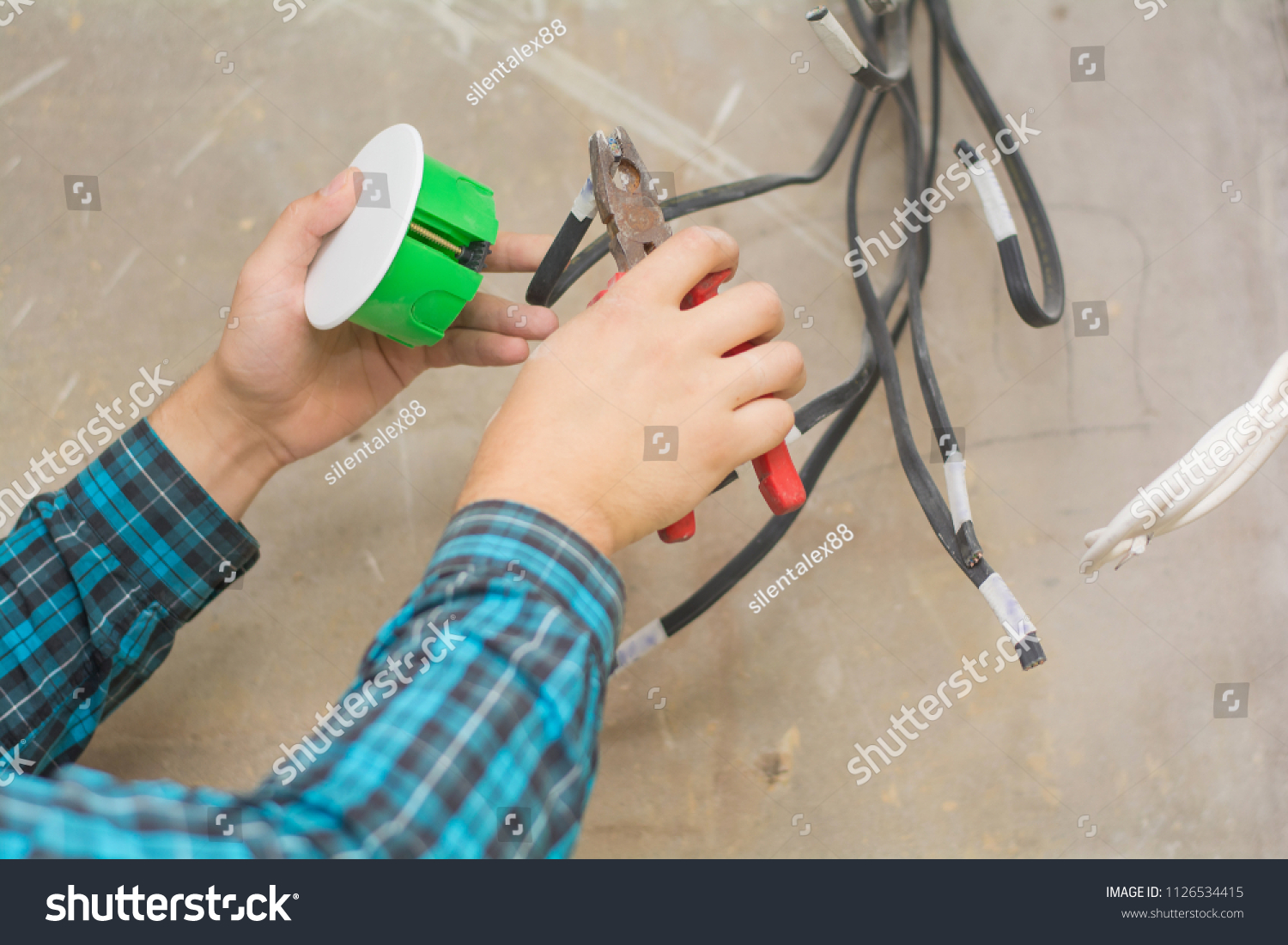 Electrician Hand Pliers During Install Mount Stock Photo