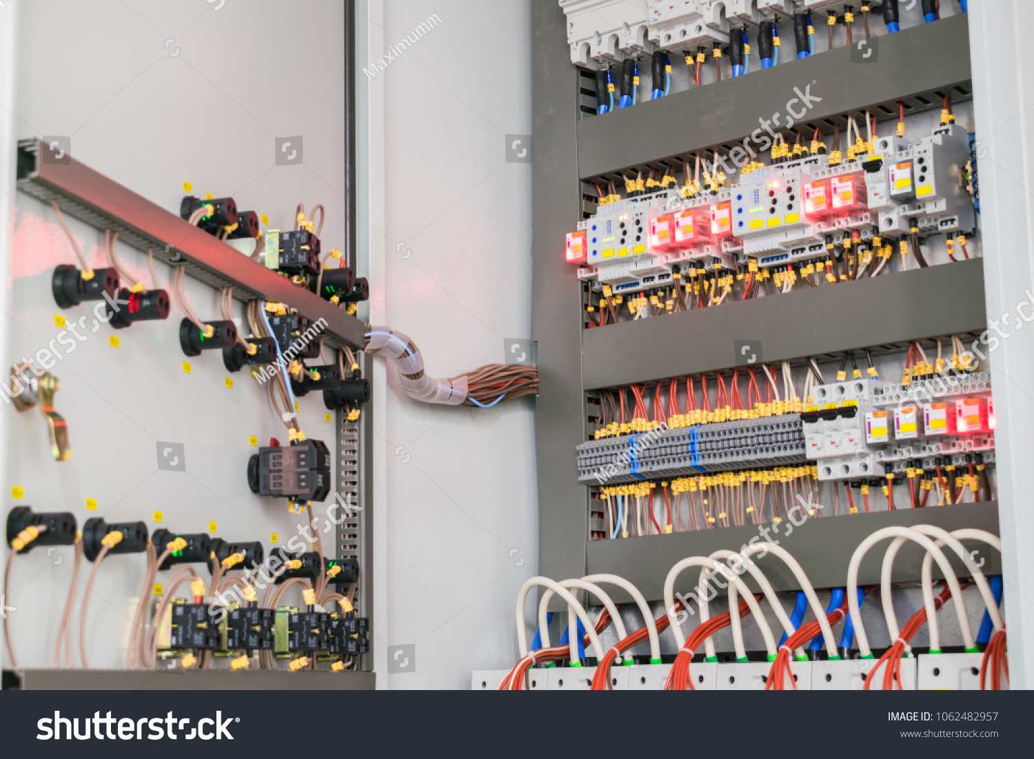 An open fuse box is on the wall in the basement. High voltage electrical control