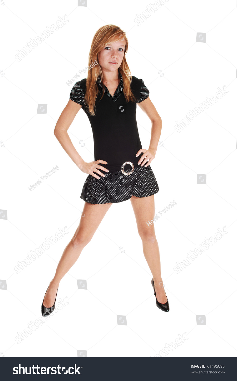 An Pretty Young Woman In An Black Short Dress And High Heels Standing ...