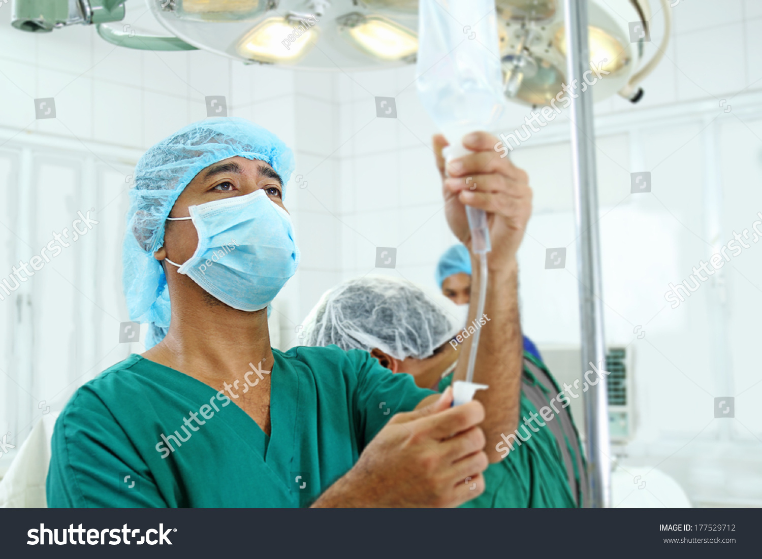 Anesthesiologist Regulating Iv Drip Inside Operating Stock