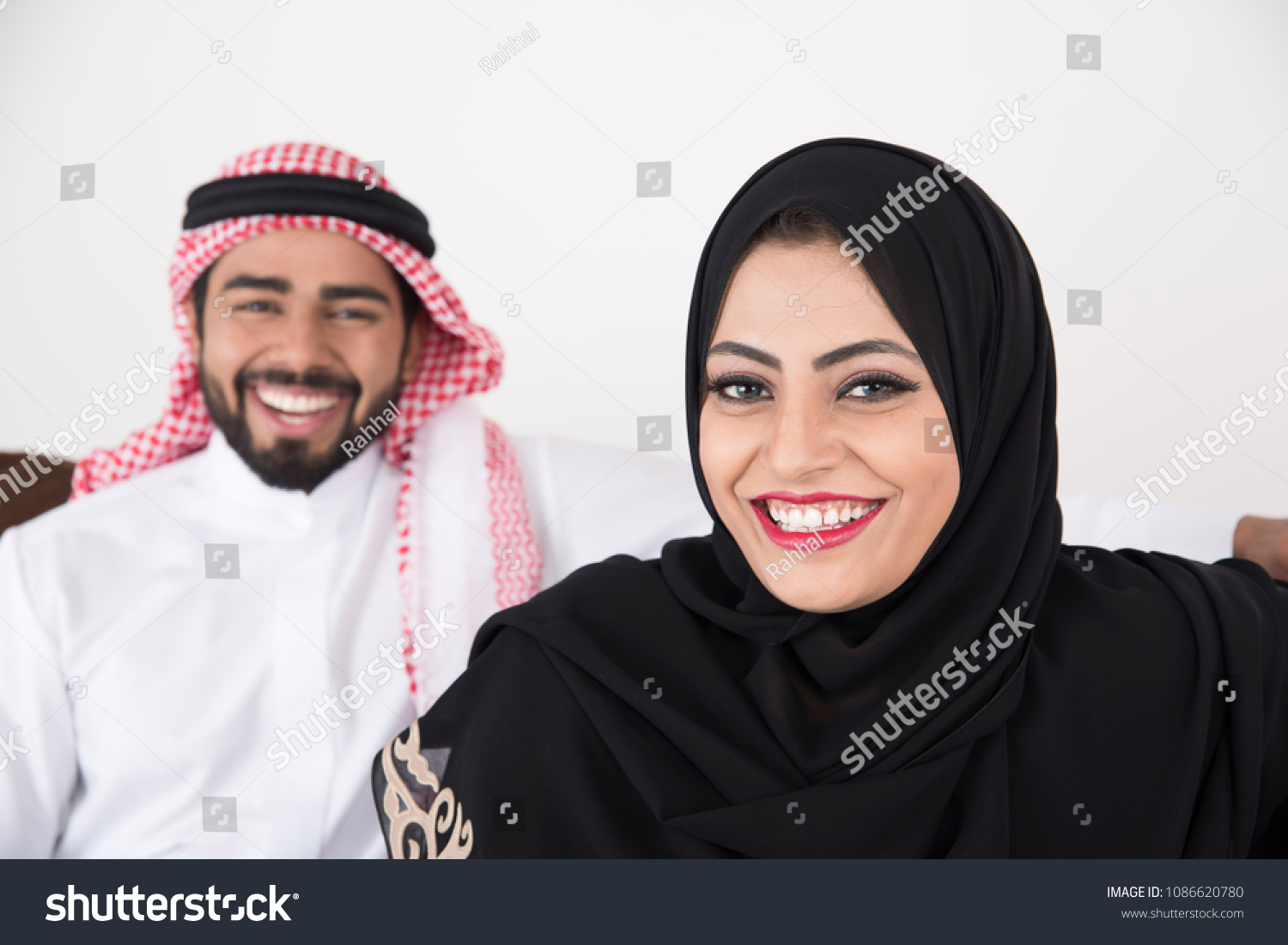 Arab Couple Sitting Home White Background Stock Photo Edit Now 1086620780   Stock Photo Arab Couple Sitting At Home With White Background 1086620780 