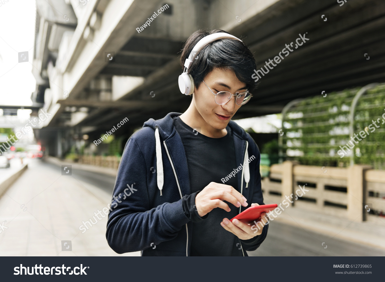 stock-photo-asian-guy-listening-music-by-headphones-612739865.jpg
