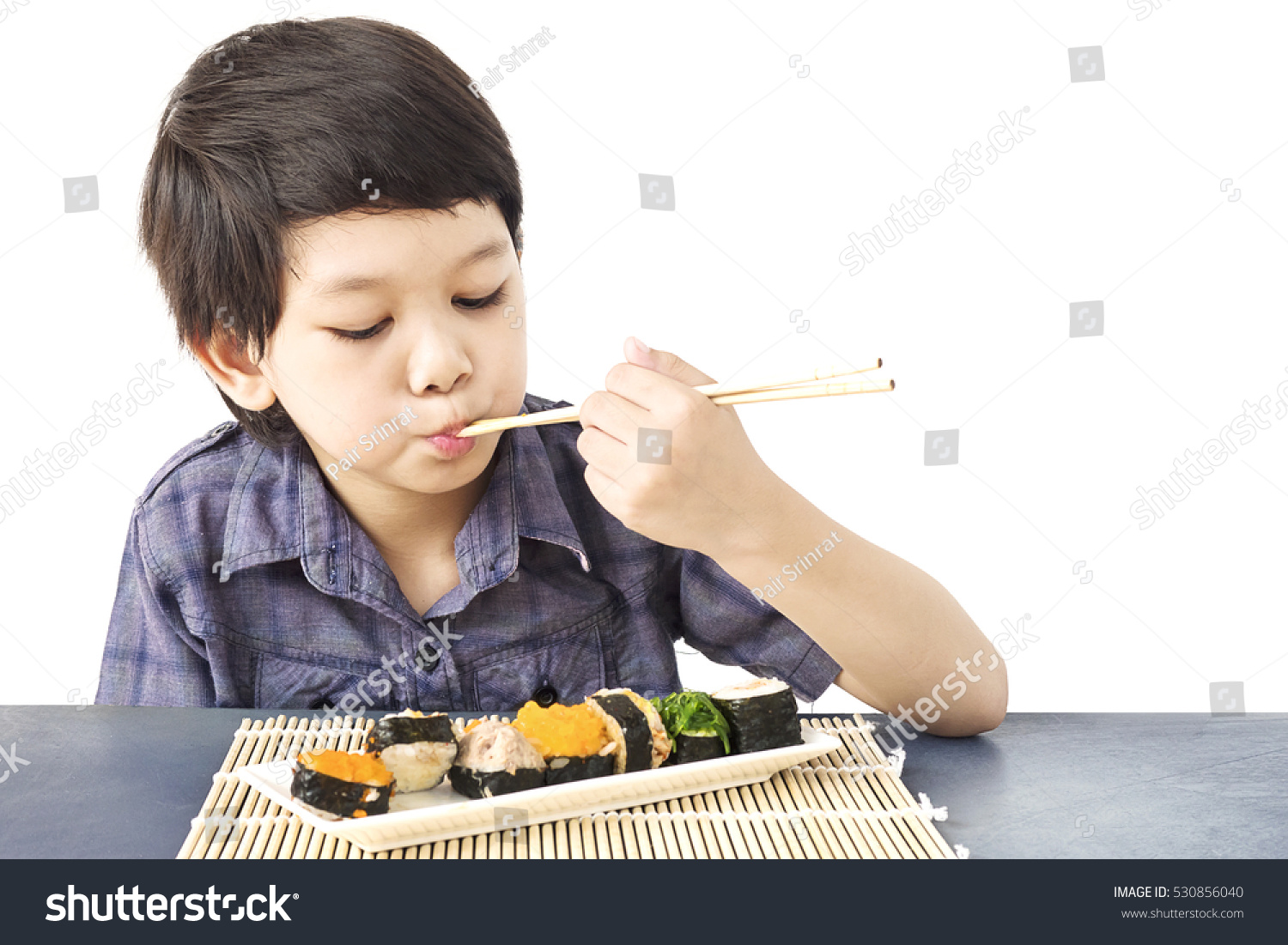 Asian Lovely Boy Is Eating Sushi Over White Background Stock Photo ...