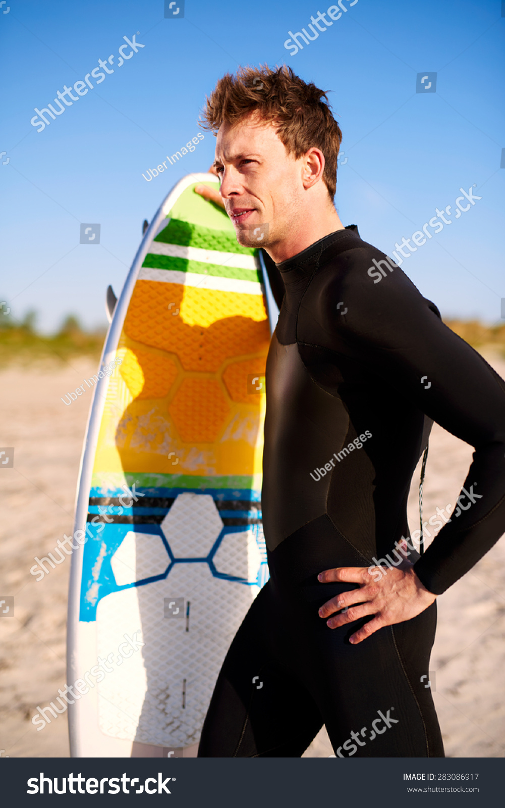 Athletic Fit Young Surfer With His Surfboard Standing On A Tropical ...