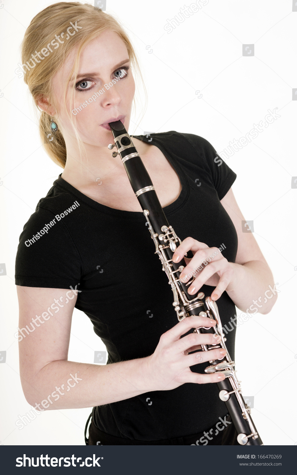 Attractive Blond Woman Practicing Her Musical Talent Playing Clarinet ...