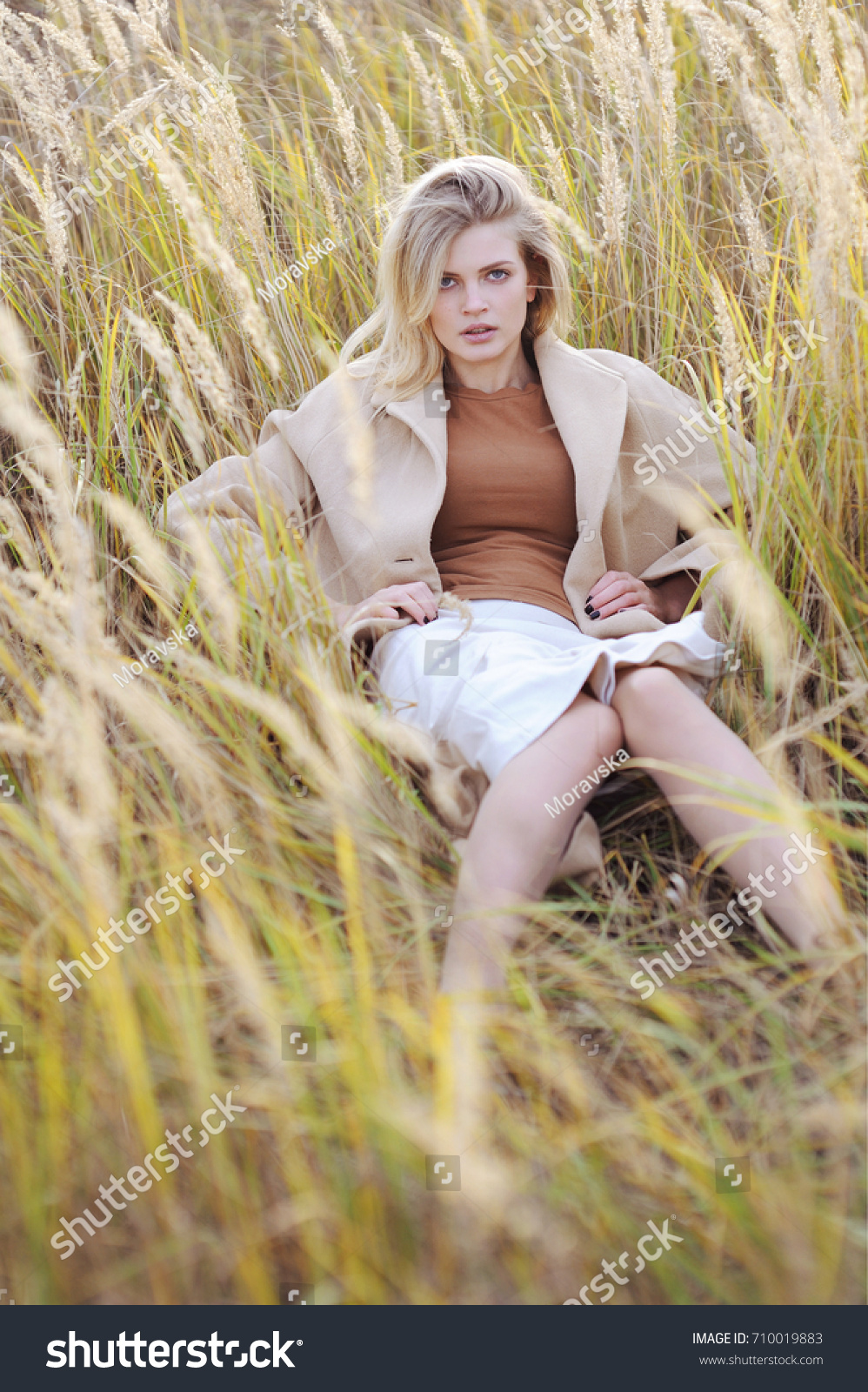 3 pretty blonde girls frolicking on the grass