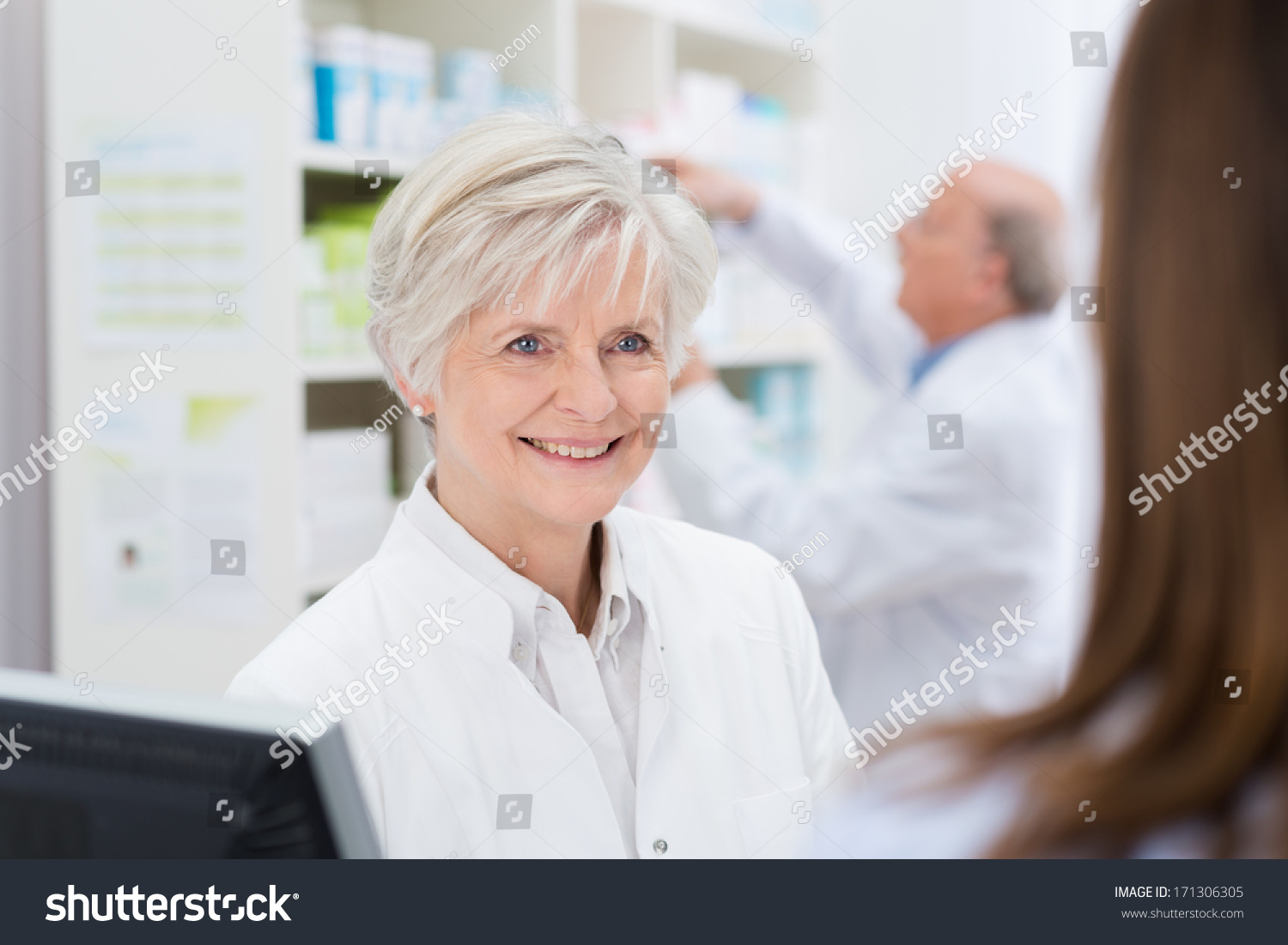 Attractive Female Pharmacist With A Warm Welcoming Smile Helping A ...