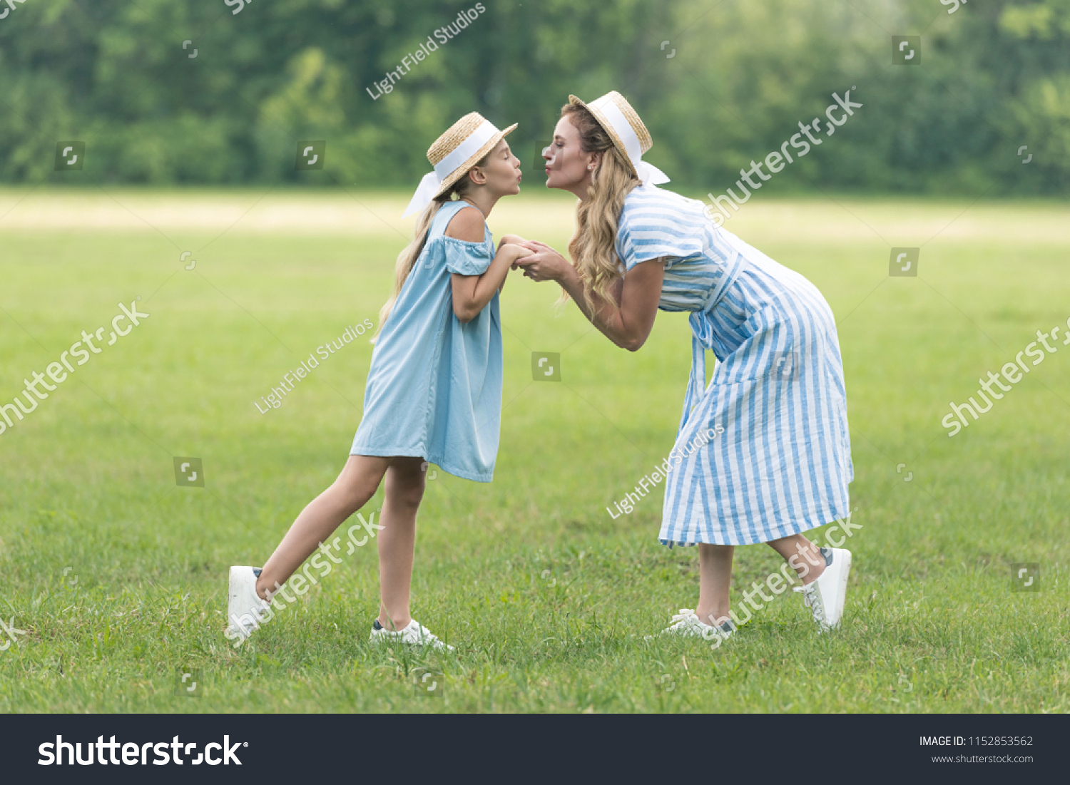 attractive-mother-adorable-daughter-holding-hands-stock-photo-edit-now