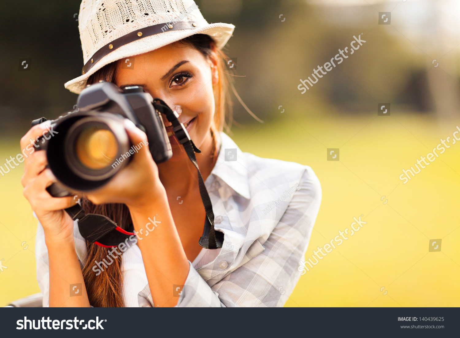 http://image.shutterstock.com/z/stock-photo-attractive-young-woman-talking-pictures-outdoors-140439625.jpg