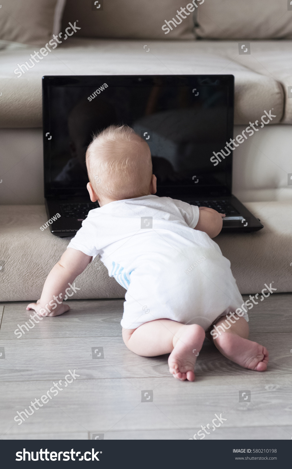 Baby Caught Laptop On Floor Royalty Free Stock Image