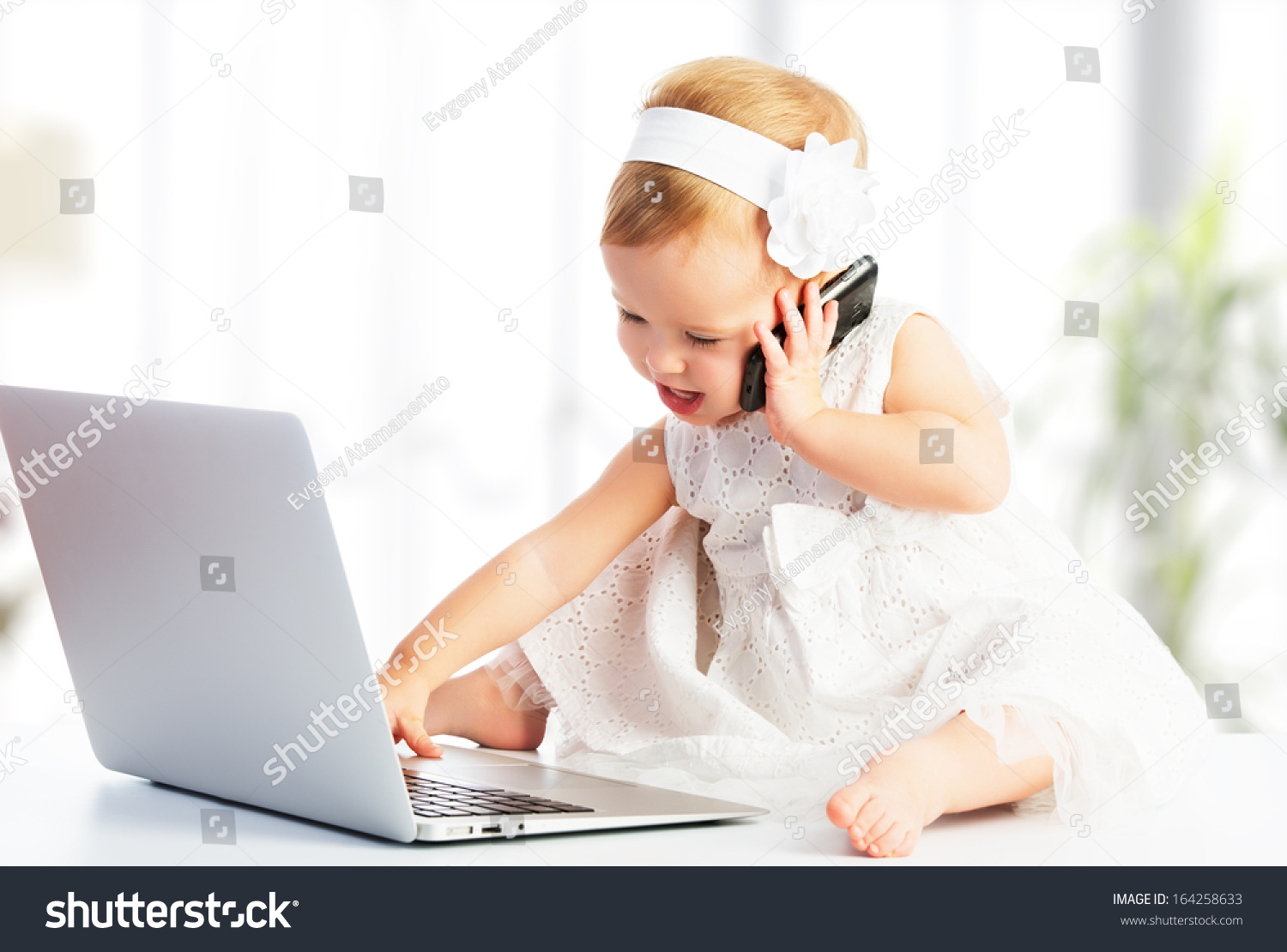 baby on a computer and phone