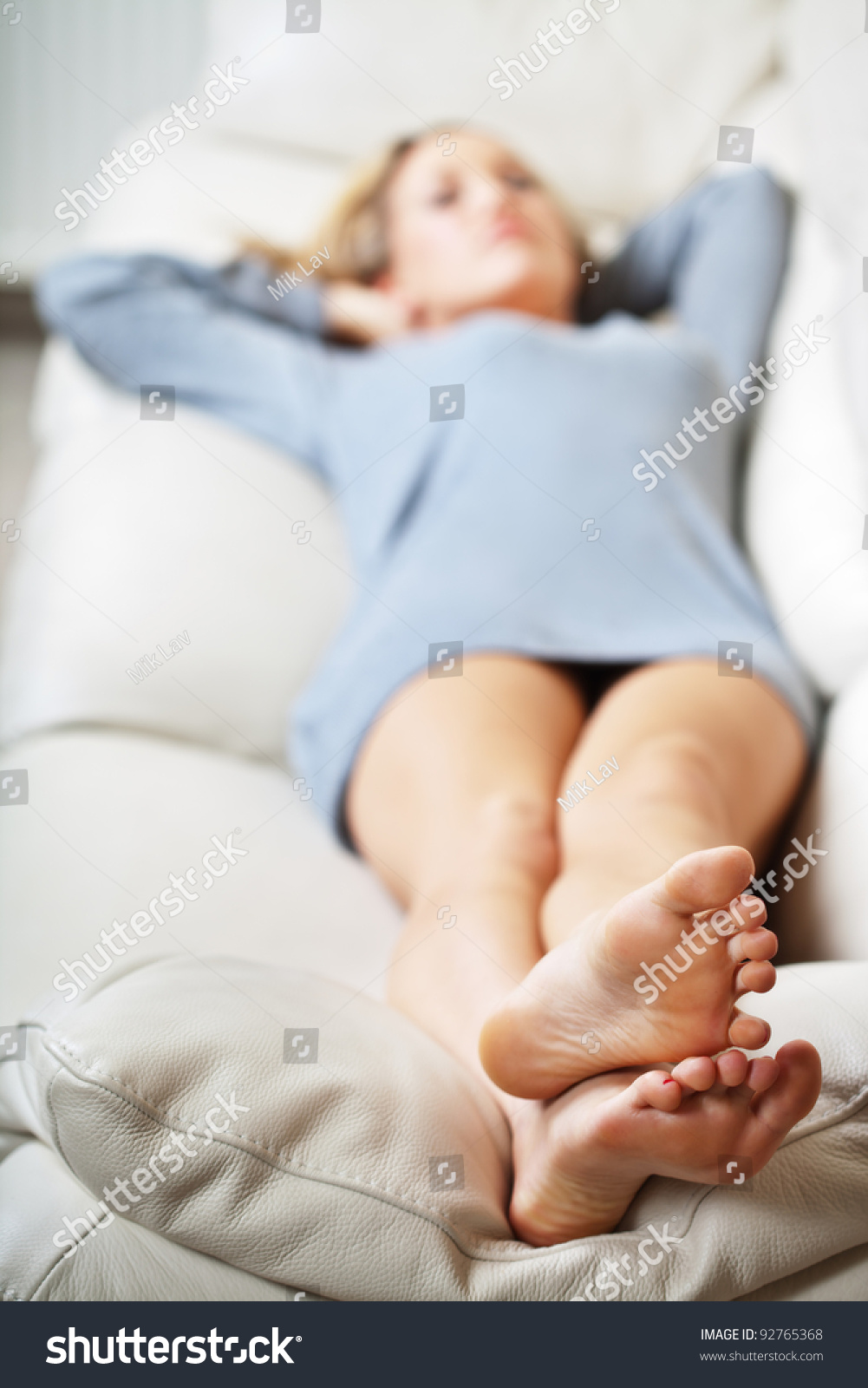 Barefoot Young Woman Lying On Sofa, Shallow Depth Of Field, Focus On ...