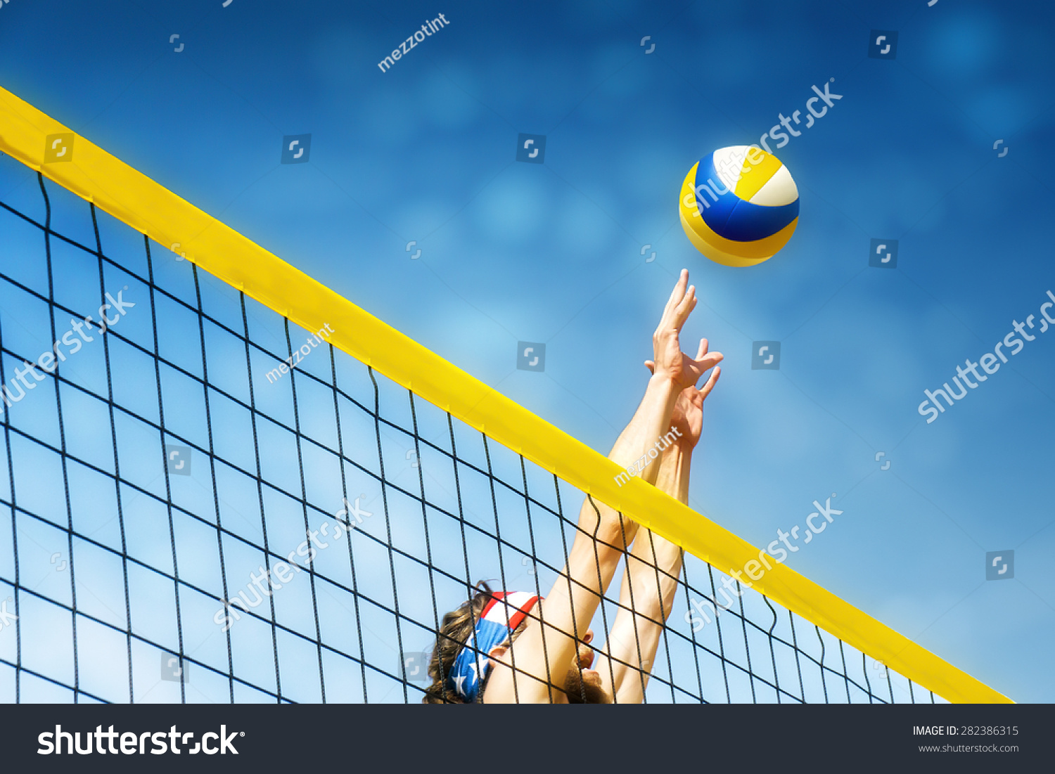 Beach Volley Ball Player Jumps On The Net And Tries To Blocks The Ball ...