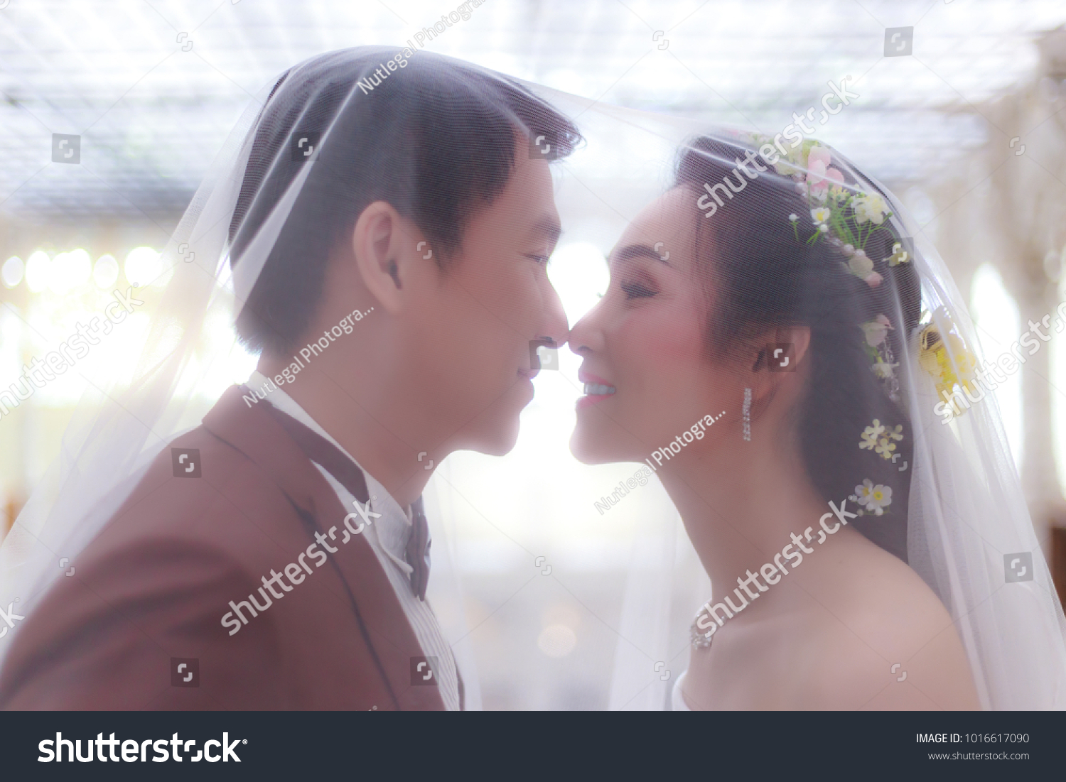 https://image.shutterstock.com/z/stock-photo-beautiful-asian-bride-get-married-with-handsome-asian-bloom-they-feel-happy-attractive-guy-is-1016617090.jpg