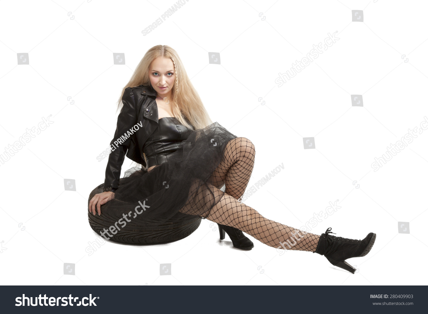 Girl in stockings and black leather boots in a car
