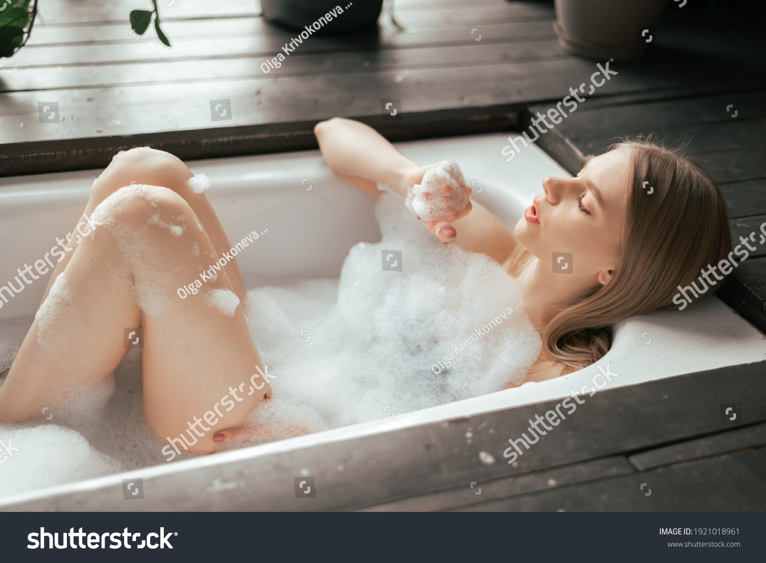 Cute blond playing with herself in the bath