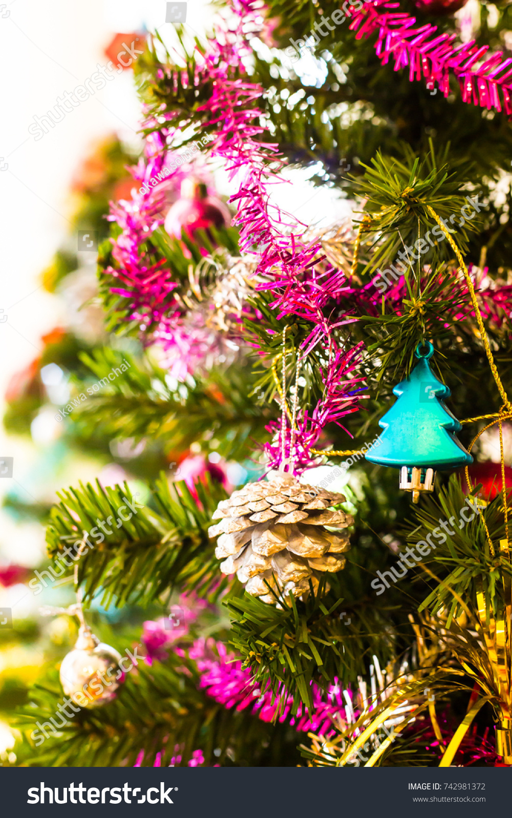 Beautiful Green Christmas Tree With Santa Cross Doll Colorful Balls Gift Of Pine Trees And Ribbons Set Aside To The Concrete Wall At Day Blur Beautiful Green Christmas Tree With Santa Cross Doll Colorful Balls Gift Of Pine Trees And Ribbons Set Aside To The Concrete Wall At Day Blur
