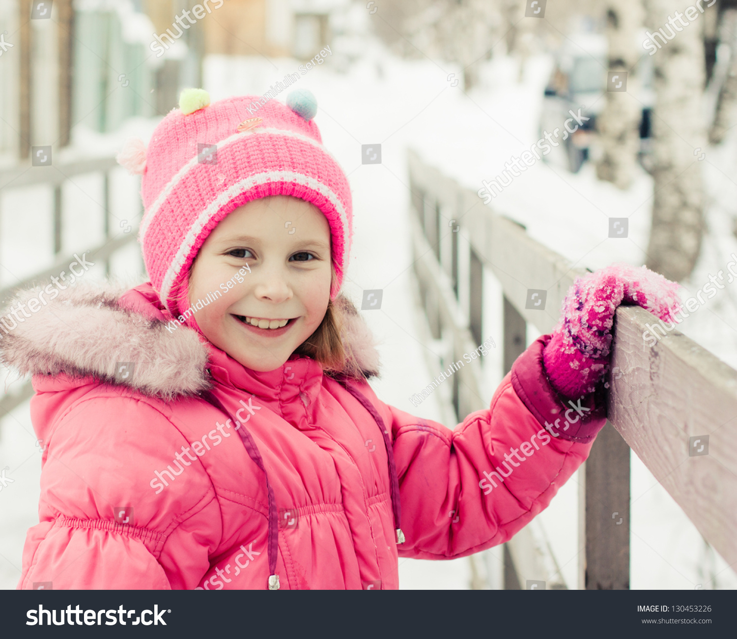 Beautiful Happy Kid On The Bridge Holding The Handrails In The Winter ...