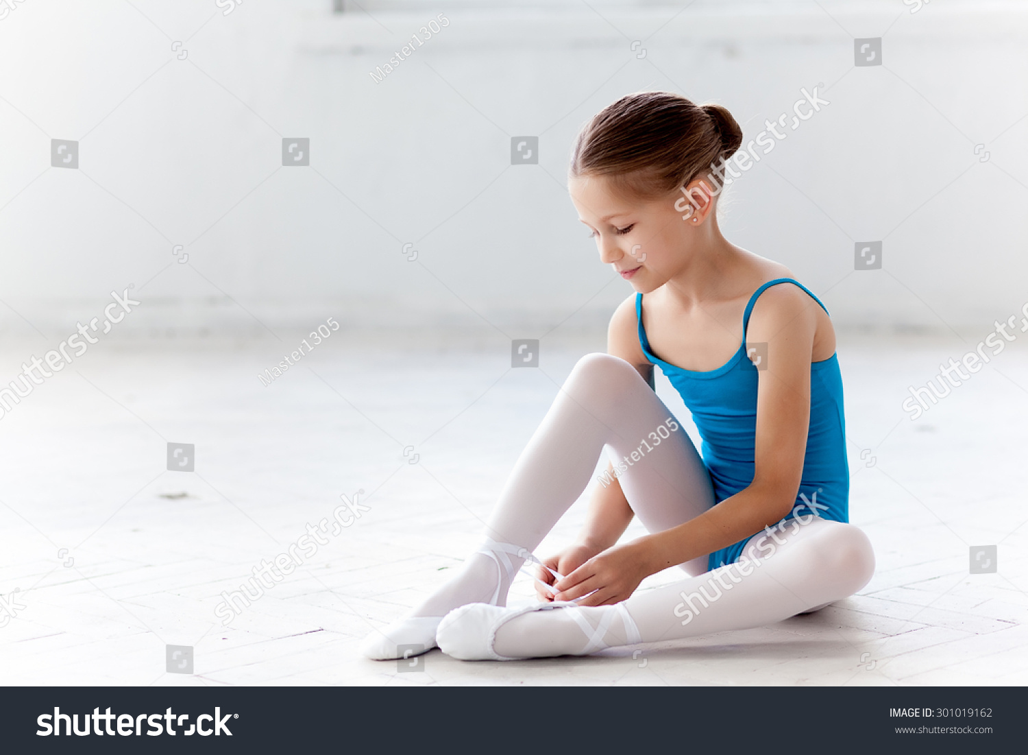 Beautiful Little Ballerina In Blue Dress For Dancing Sitting On The ...