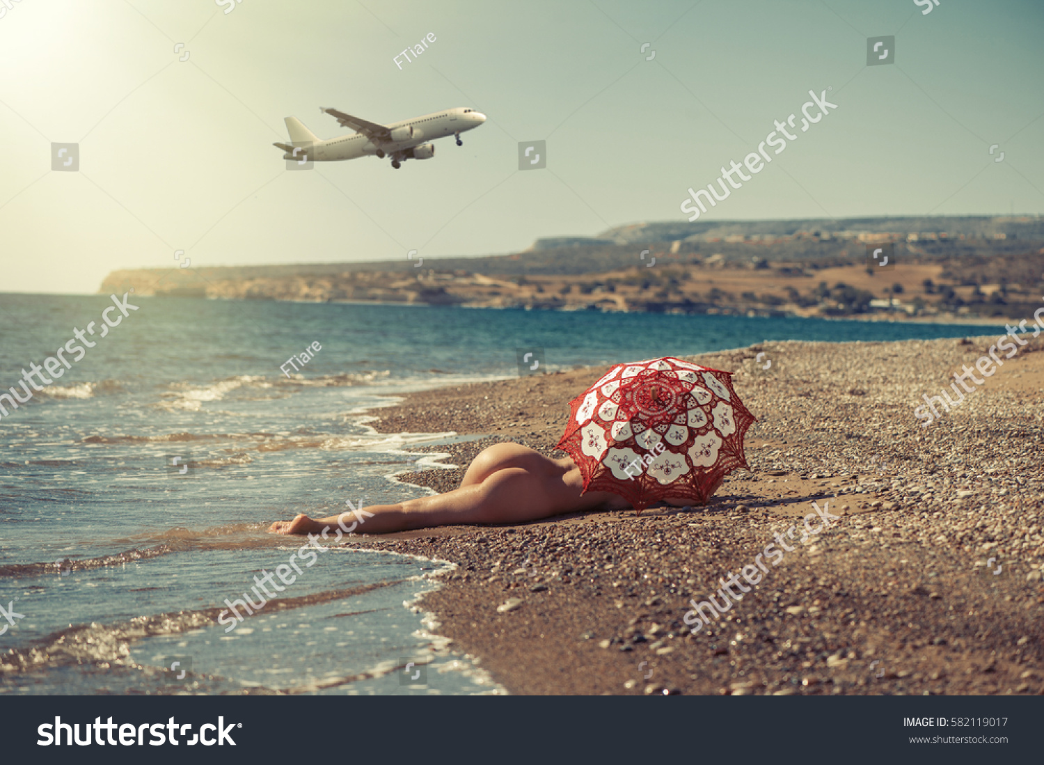 girl laying naked in beach