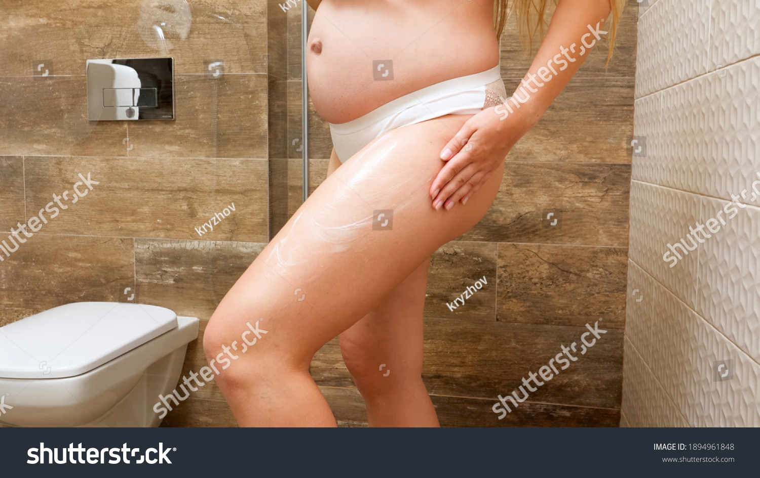 Toilet pissing woman stretching her butt cheeks over bowl