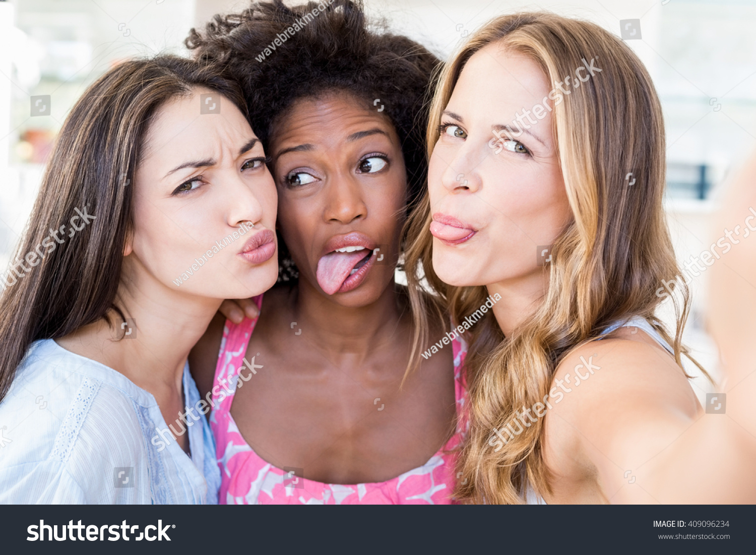 beautiful-women-making-funny-faces-home-stock-photo-409096234