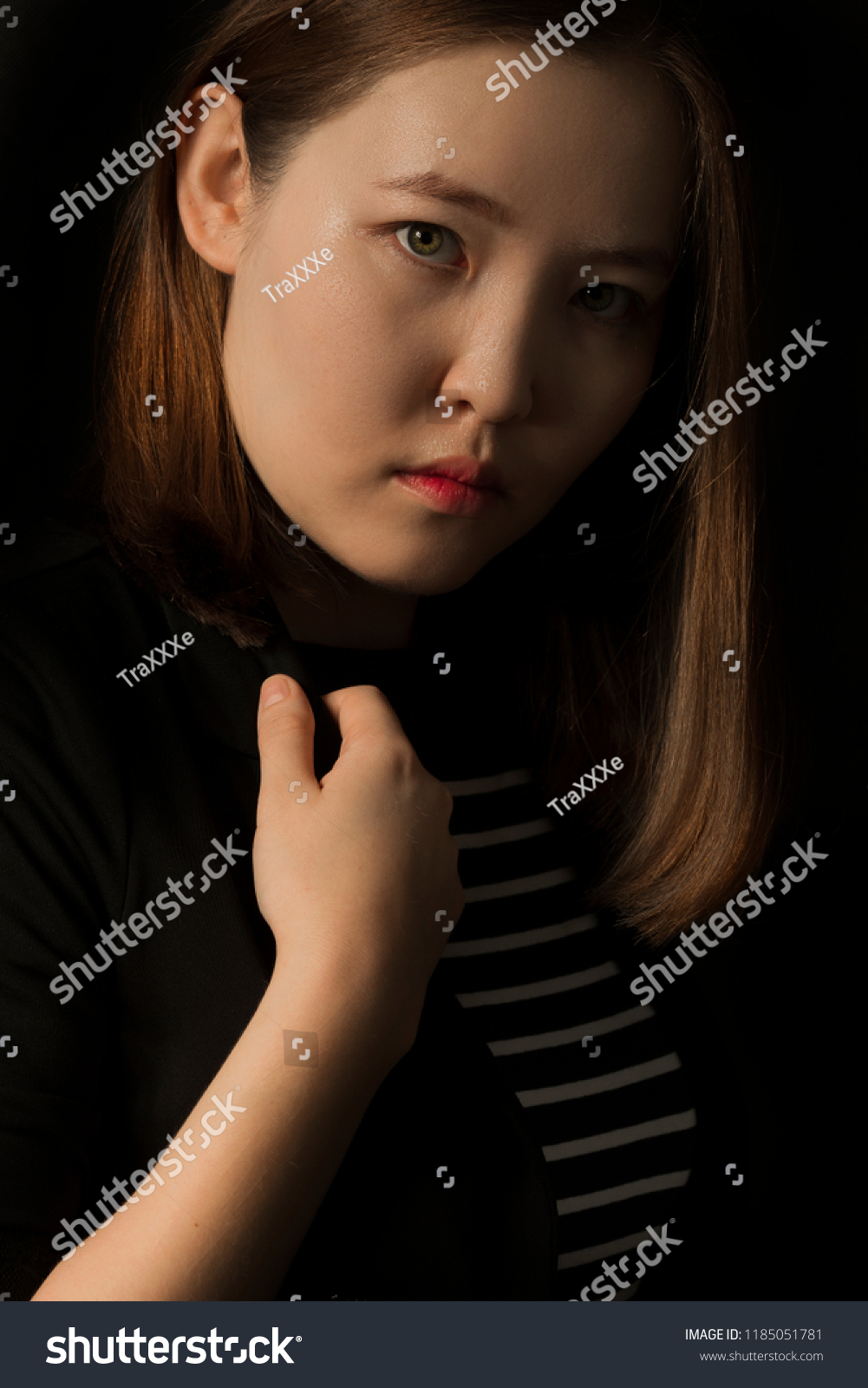 https://image.shutterstock.com/z/stock-photo-beautiful-young-mongolian-woman-on-dark-background-fashion-look-1185051781.jpg