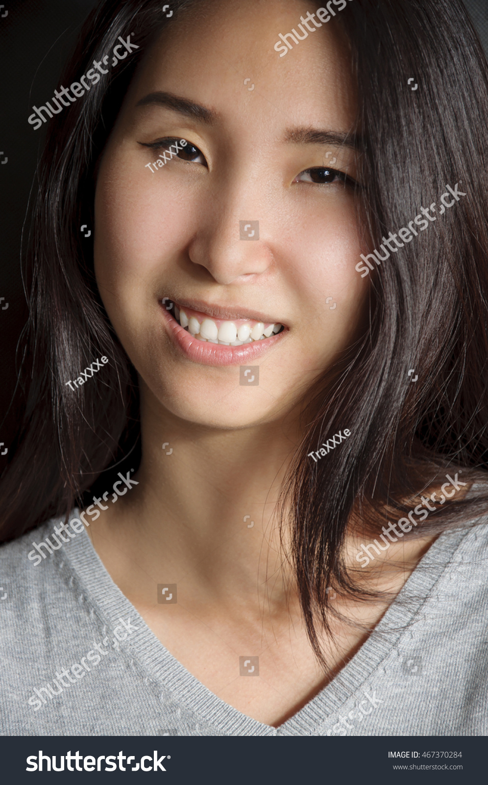 https://image.shutterstock.com/z/stock-photo-beautiful-young-mongolian-woman-on-dark-background-with-gray-shirt-467370284.jpg