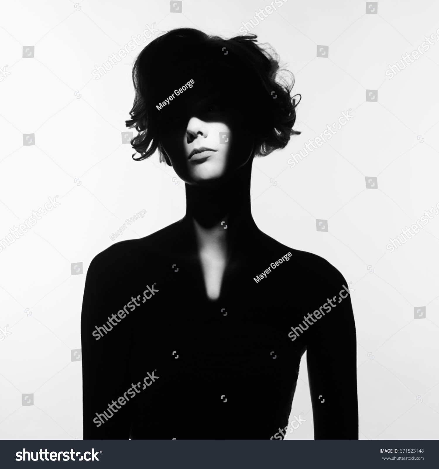 Black and white art fashion surrealistic portrait of beautiful woman with a beam of light on