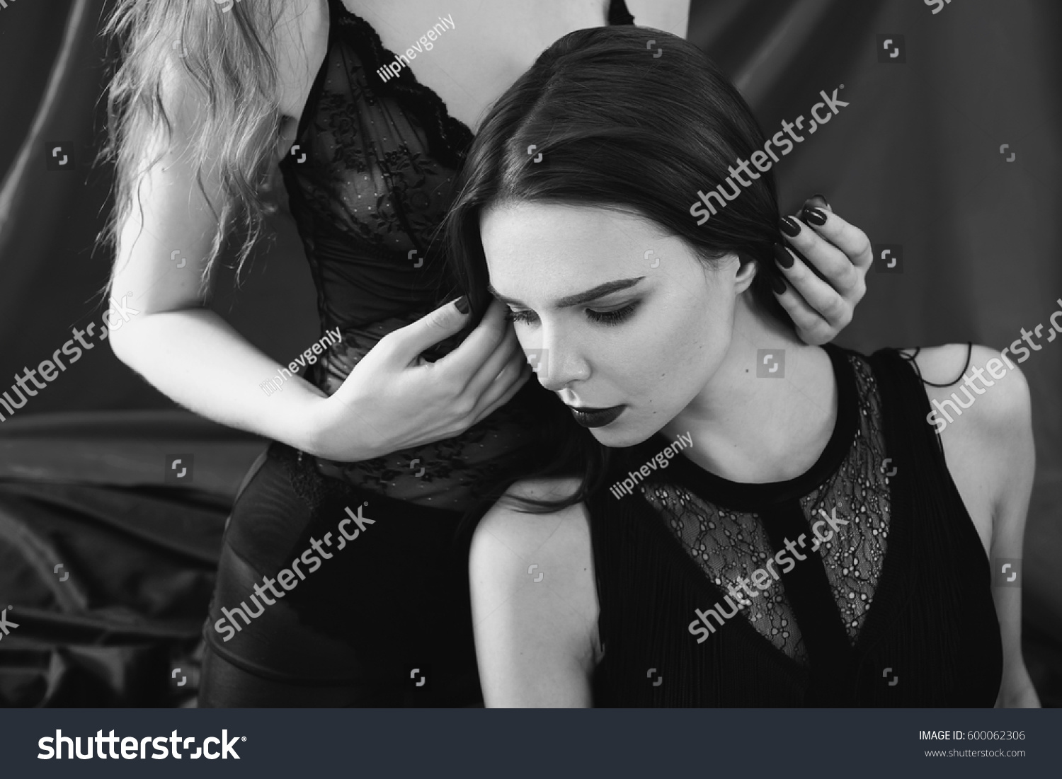 Black and white art photography monochrome two girls hug on the black background two