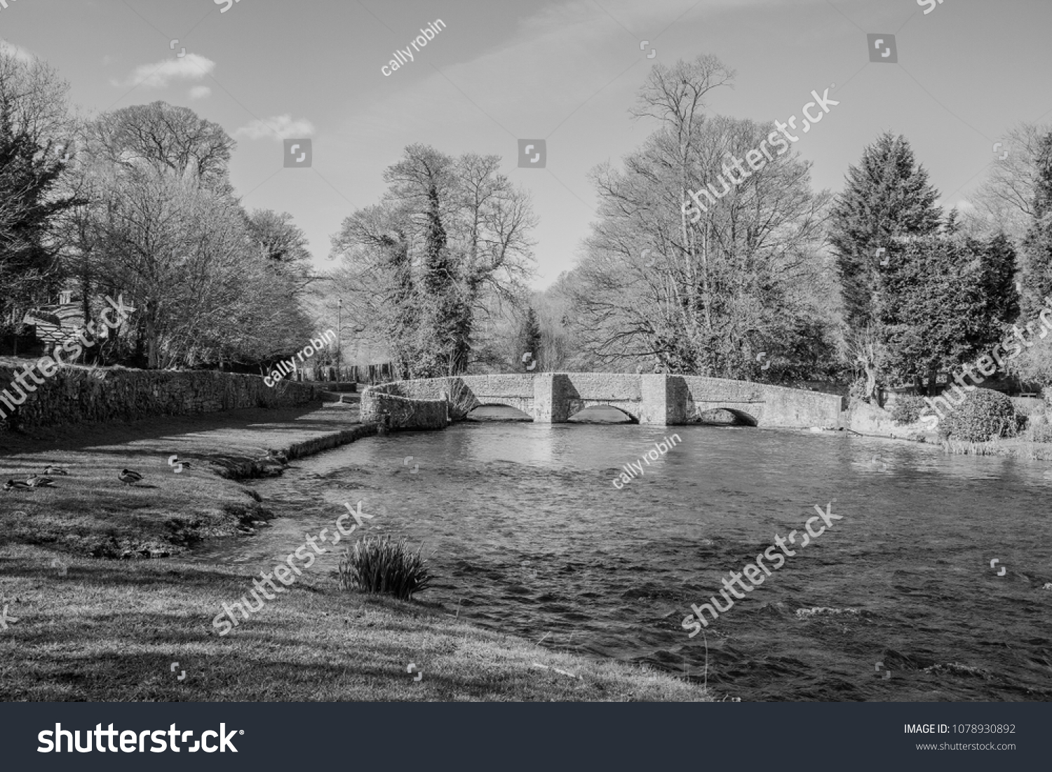 Black and white photography of the medieval sheepwash bridge and river wye at ashford in the