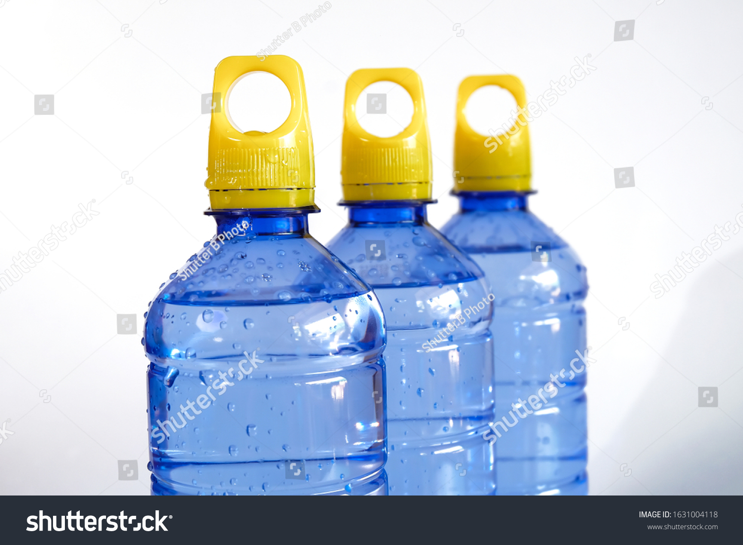 Download Blue Water Bottle Yellow Cap Holding Stock Photo Edit Now 1631004118 PSD Mockup Templates