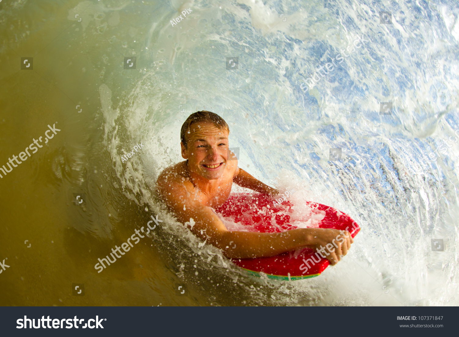 Boogie Boarder Surfing A Wave, Riding In The Tube Or Barrel Stock Photo ...