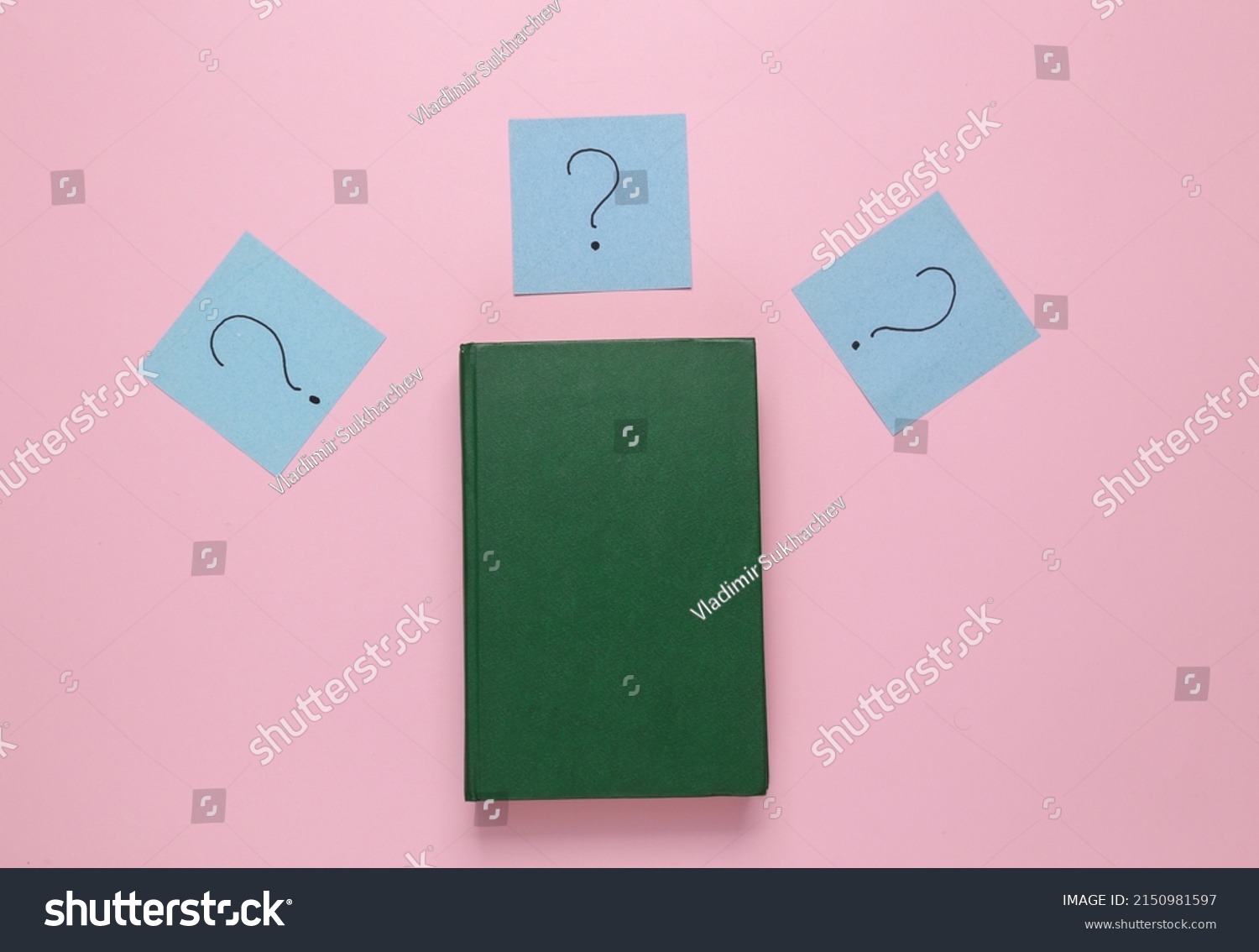 book-question-marks-on-pink-background-stock-photo-2150981597