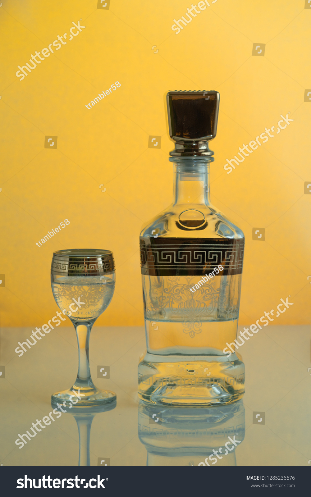 Download Bottle Glass Alcohol On Yellow Background Stock Photo Edit Now 1285236676 PSD Mockup Templates