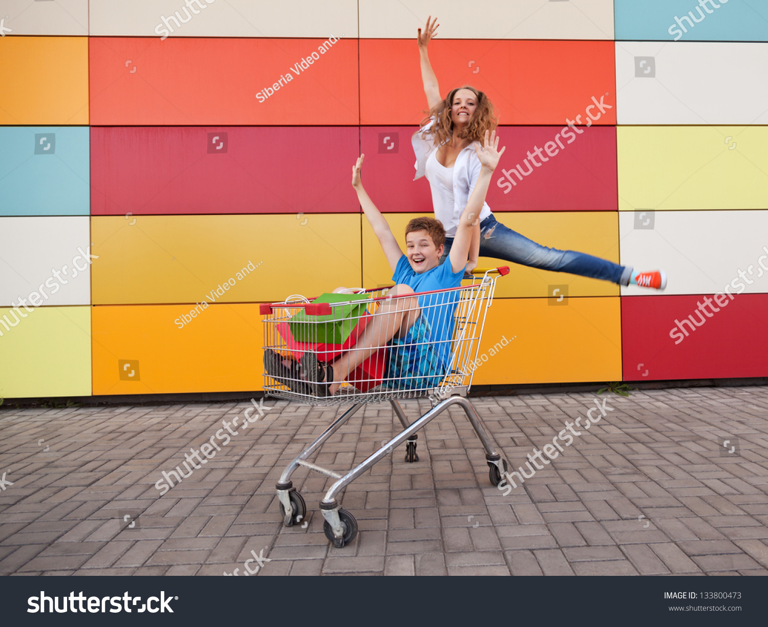 Boy And Girl With Shopping Trolley Full Of Purchases In The Street ...