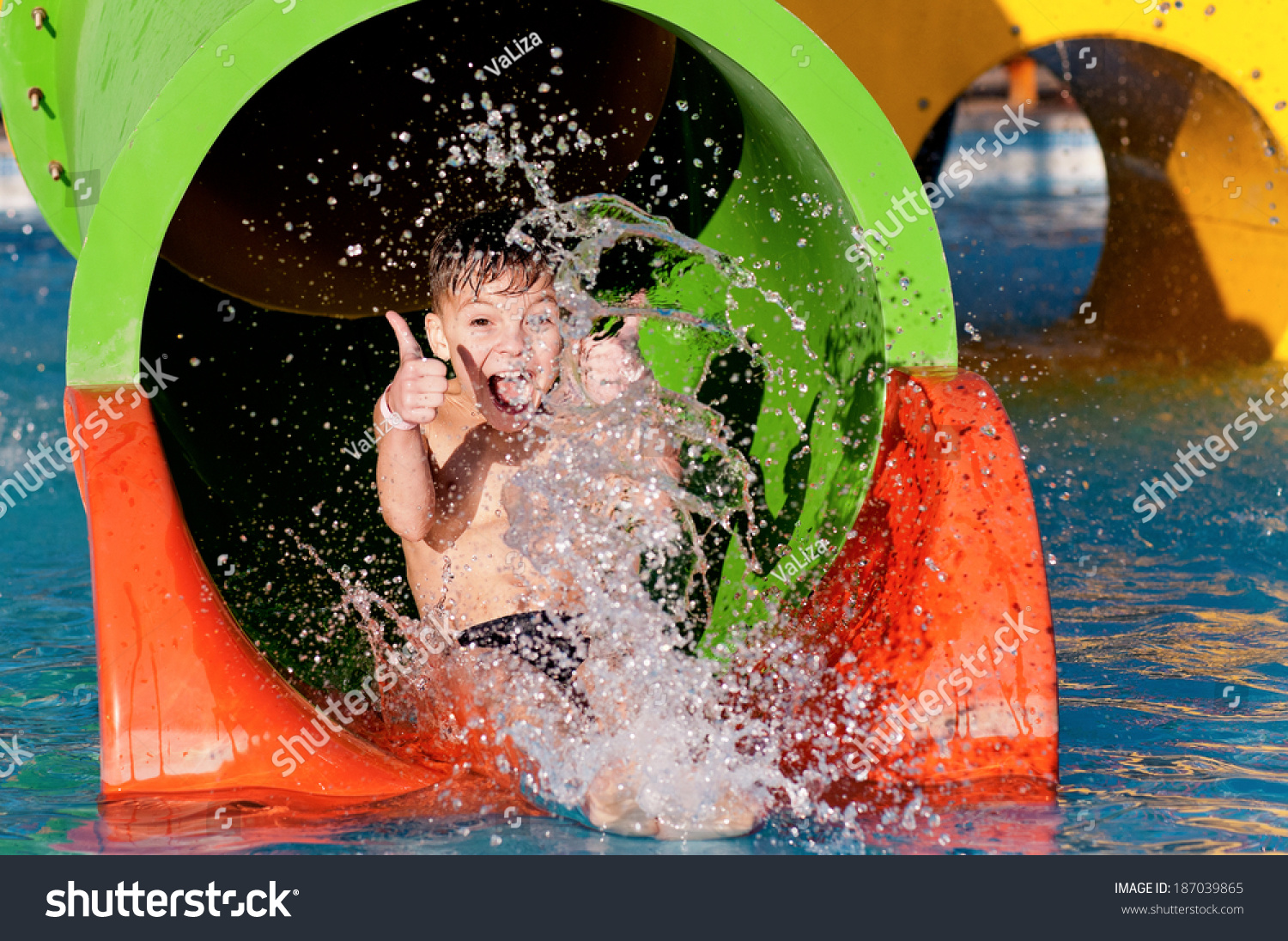 Boy Has Into Pool After Going Down Water Slide During Summer Stock ...