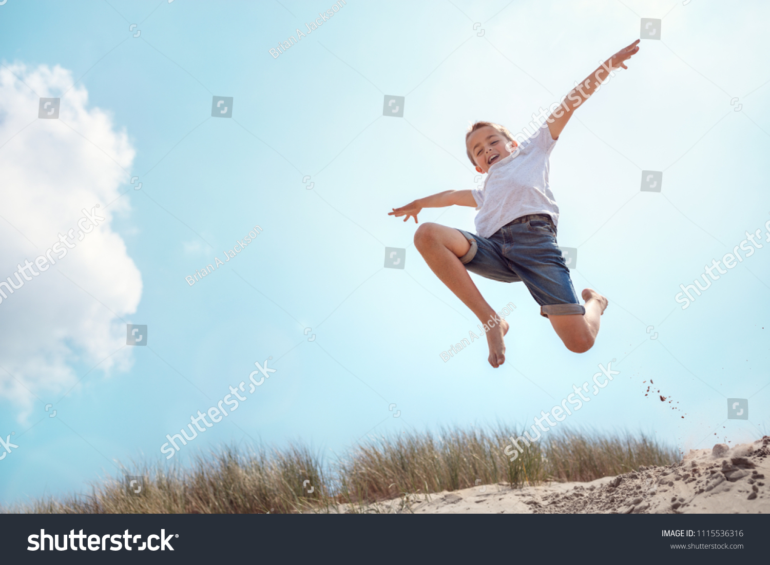 Boy Leaping Jumping Over Sand Dune Stock Photo 1115536316 | Shutterstock