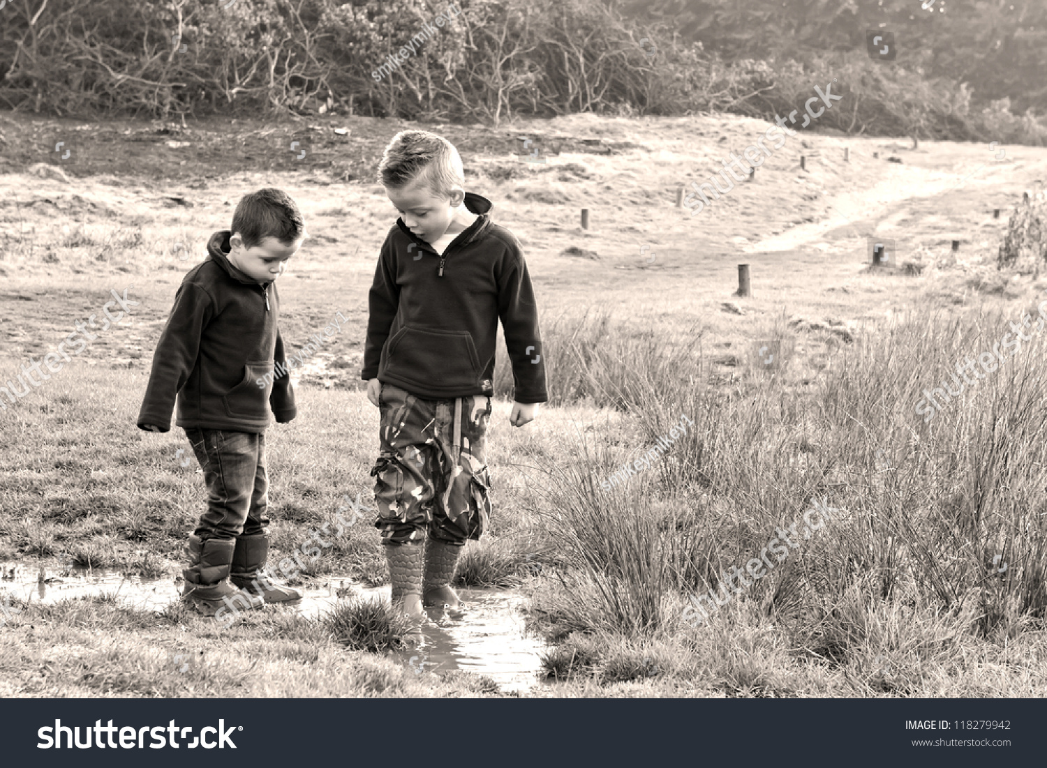 Boys Playing In A Muddy Puddle Stock Photo 118279942 : Shutterstock