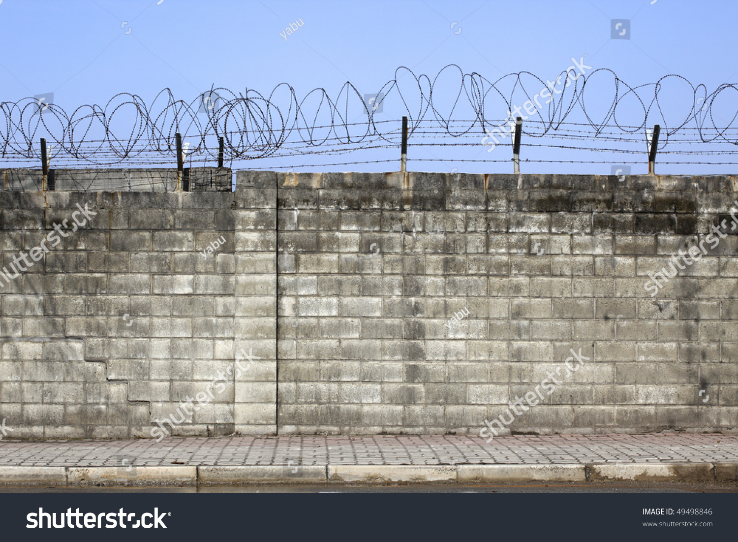 Brick Wall With Barbed Wire